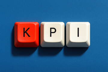 A concept performance measurement is depicted by three keyboard keys aligned horizontally on a matte blue surface symbolizing business focus and progress