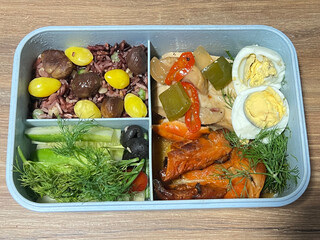 Black pepper stir-fried chicken breast, grilled Thai Hor Mok, and boiled egg, served with brown...
