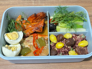 Black pepper stir-fried chicken breast, grilled Thai Hor Mok, and boiled egg, served with brown...