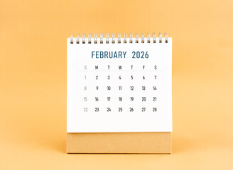 February 2026 desk calendar on yellow background, Front view.
