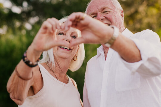 senior couple doing hand hearts