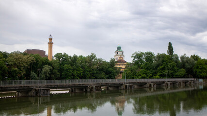 Historical Church Tower and Building in Munich Under a Cloudy Sky