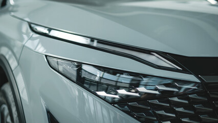 Close-up of car headlights in an automobile showroom. An advanced design concept that improves...