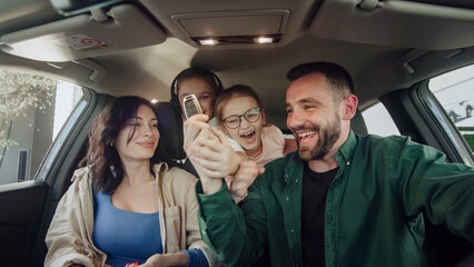 A happy young family gets the keys to their new car at a modern car dealership. The end of a test...