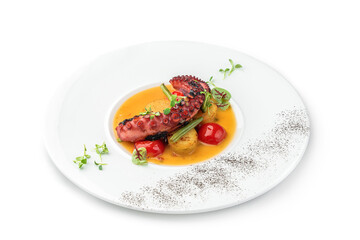 Grilled octopus with vegetables and sauce in plate isolated on white background. Healthy food, top view, close up