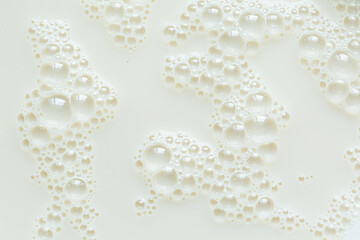 Macro milk surface close-up,Macro milk texture,White surface of milk and bubbles and ripples from above birds eye view