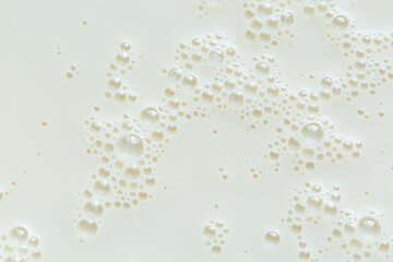 Macro milk surface close-up,Macro milk texture,White surface of milk and bubbles and ripples from above birds eye view