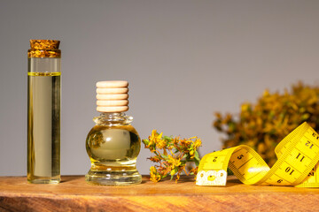 Hypericum - St. St. John's wort herbs, oil or infusion bottle, mortar on a wooden board.