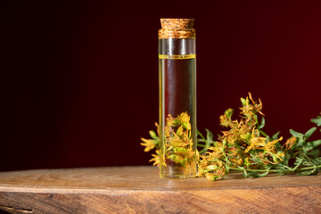 Hypericum - St. St. John's wort herbs, oil or infusion bottle, mortar on a wooden board.