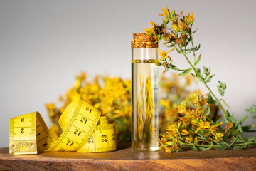 Hypericum - St. St. John's wort herbs, oil or infusion bottle, mortar on a wooden board.