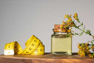 Hypericum - St. St. John's wort herbs, oil or infusion bottle, mortar on a wooden board.