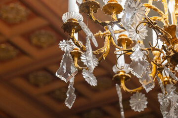 Vintage chandelier adorned with intricate gold details and crystal accents