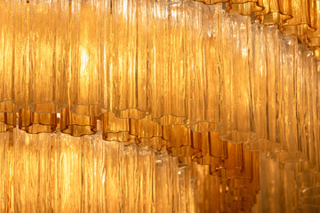 Elegant chandelier macro photo featuring amber colored glass pieces