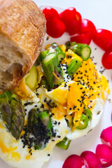 Delicious Breakfast with Poached Eggs, Asparagus, and Black Sesame Seeds