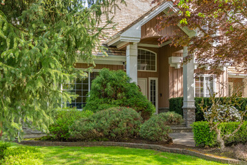 Entrance of grey painted luxury house in spring with stair steps and nice landscape in Vancouver, Canada, North America. Day time on May 2025.