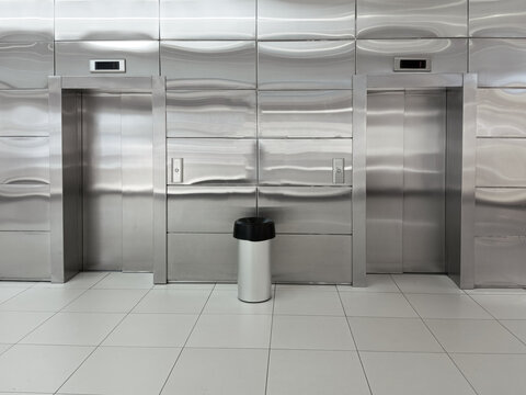 Silvery grey closed elevator doors in a building.
