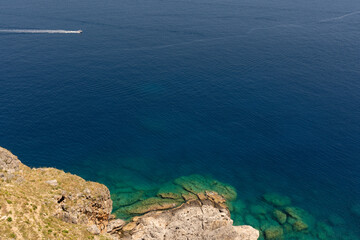 Rocky Shoreline Meeting Clear Blue Sea