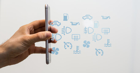 Hand holding phone with various car warning icons. Perfect for auto repair, maintenance, or technology concepts.