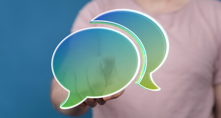 Image depicts a person interacting with digital speech bubbles, symbolizing communication,...