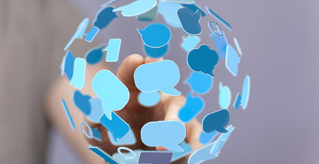 Image depicts a hand interacting with a sphere of blue speech bubbles, symbolizing global...