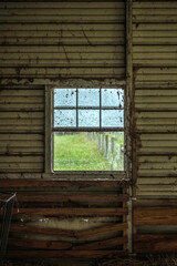 Close-up of an old window on an old wooden wall.