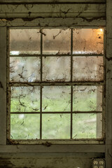 Close-up of an old window on an old wooden wall.