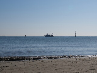 Po Delta, Ferrara province, northern Italy. Volano beach, panorama with fishing boat.