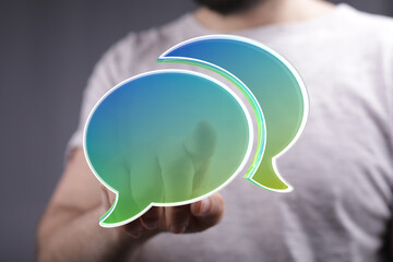 Abstract image of person holding digital speech bubbles, ideal for communication, conversation, and...