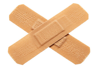 Isolated Two Beige Adhesive Bandages Crossed