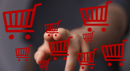 Person interacts with virtual shopping carts, showcasing online shopping and e-commerce.