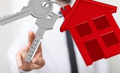 Hand holding house keys, symbolizing homeownership, real estate, and property.