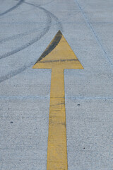 Tire marks create patterns on empty parking lot surface