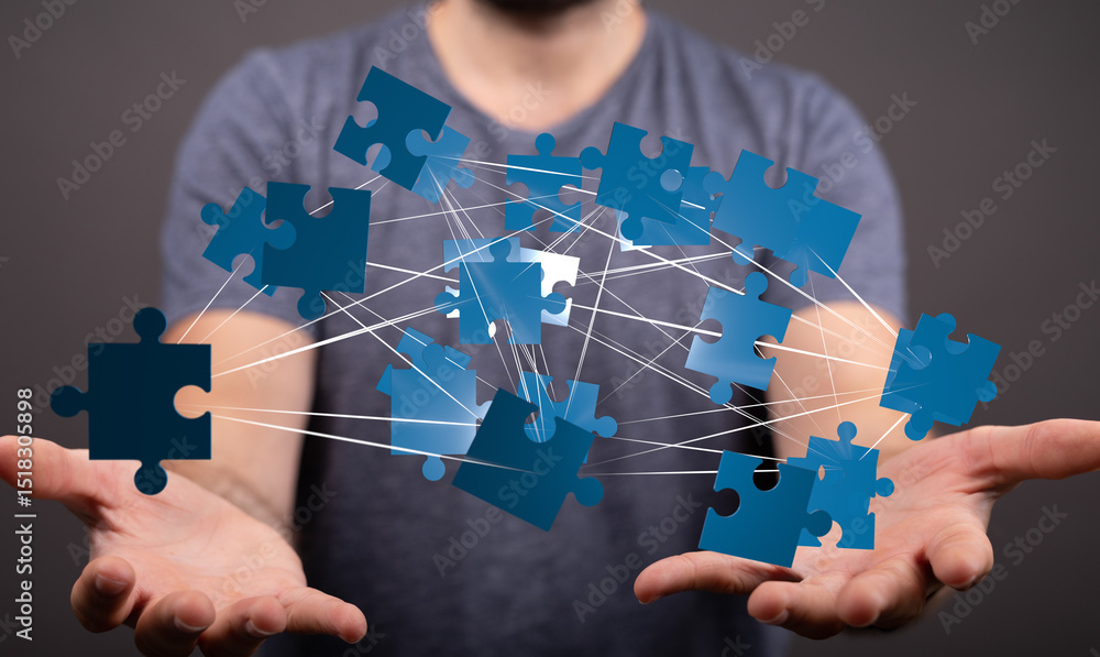 Poster image of hands holding interconnected puzzle pieces, symbolizing teamwork, collaboration, and proble