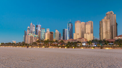 Modern skyscrapers day to night timelapse in jumeirah beach residence in Dubai, JBR