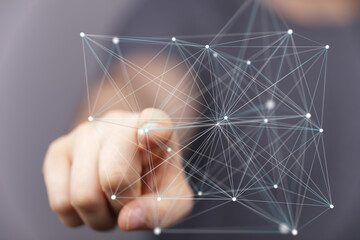 Abstract image depicting a hand interacting with a complex network, ideal for technology,...