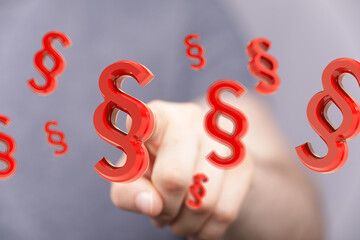 Abstract image of a hand interacting with 3D paragraph symbols, perfect for legal, law, and justice...