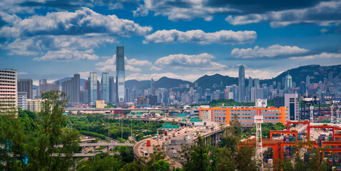 Naklejka premium Hong Kong city on dramatic sky at sunset view from mountain.