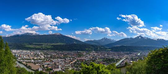Stunning aerial panorama view of Innsbruck citys and the massif of alps in south Tyrol from Hungerburg cable car station in spring on a sunny day, Innsbruck, Austria