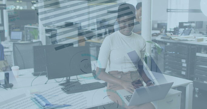 Image of data processing over african american businesswoman using laptop in office