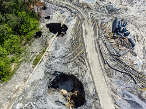 Aerial view of the pits and craters formed by the collapse of the Praid salt mine - Romania