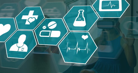 Image of medical icons over women using vr headset