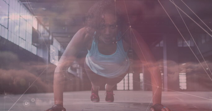 Image of network of connections over clouds and fit african american woman doing push ups