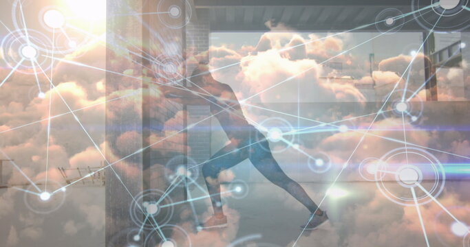 Image of network of connections and sky with clouds over african american woman exercising