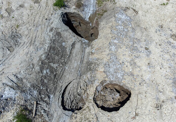 Aerial view of the place where the ground collapsed, forming holes due to the erosion of the ceiling of the salt mine in Praid - Romania