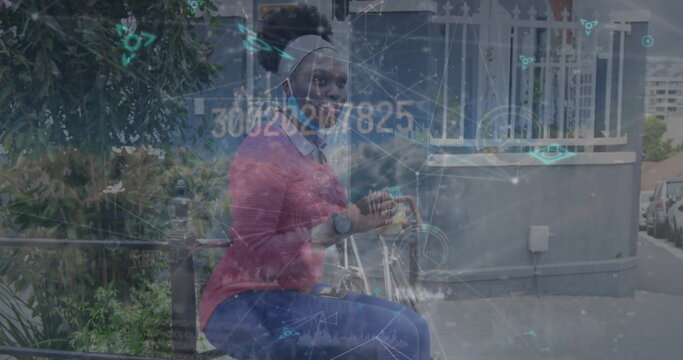 Image of network of connections over clouds and african american woman with bike