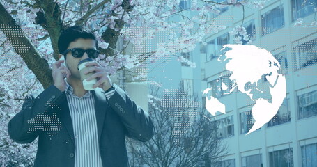 Image of world map and globe over caucasian businessman with smartphone