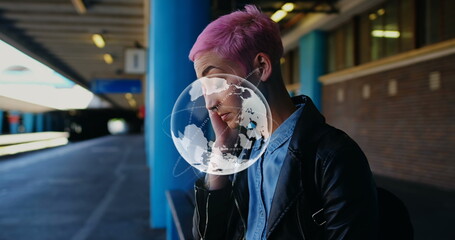 Image of globe and processing data over caucasian woman with pink hair waiting at station
