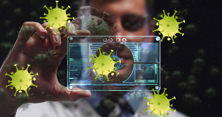 Image of virus yellow cells over caucasian male doctor with digital card with virus data