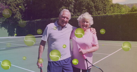 Image of falling tennis ball over caucasian senior couple on the tennis court