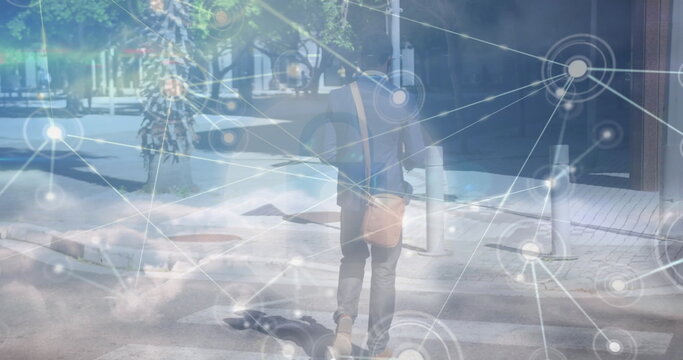 Image of network of connections and sky with clouds over african american walking